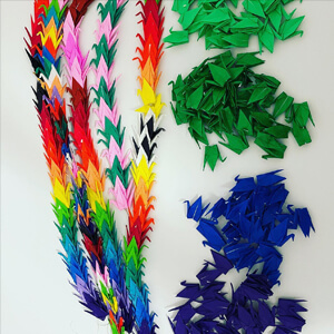 multi colored origami swan's stringed together.
