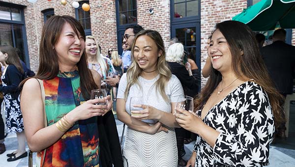 BRAVO! Club members at an outdoor event talking and laughing