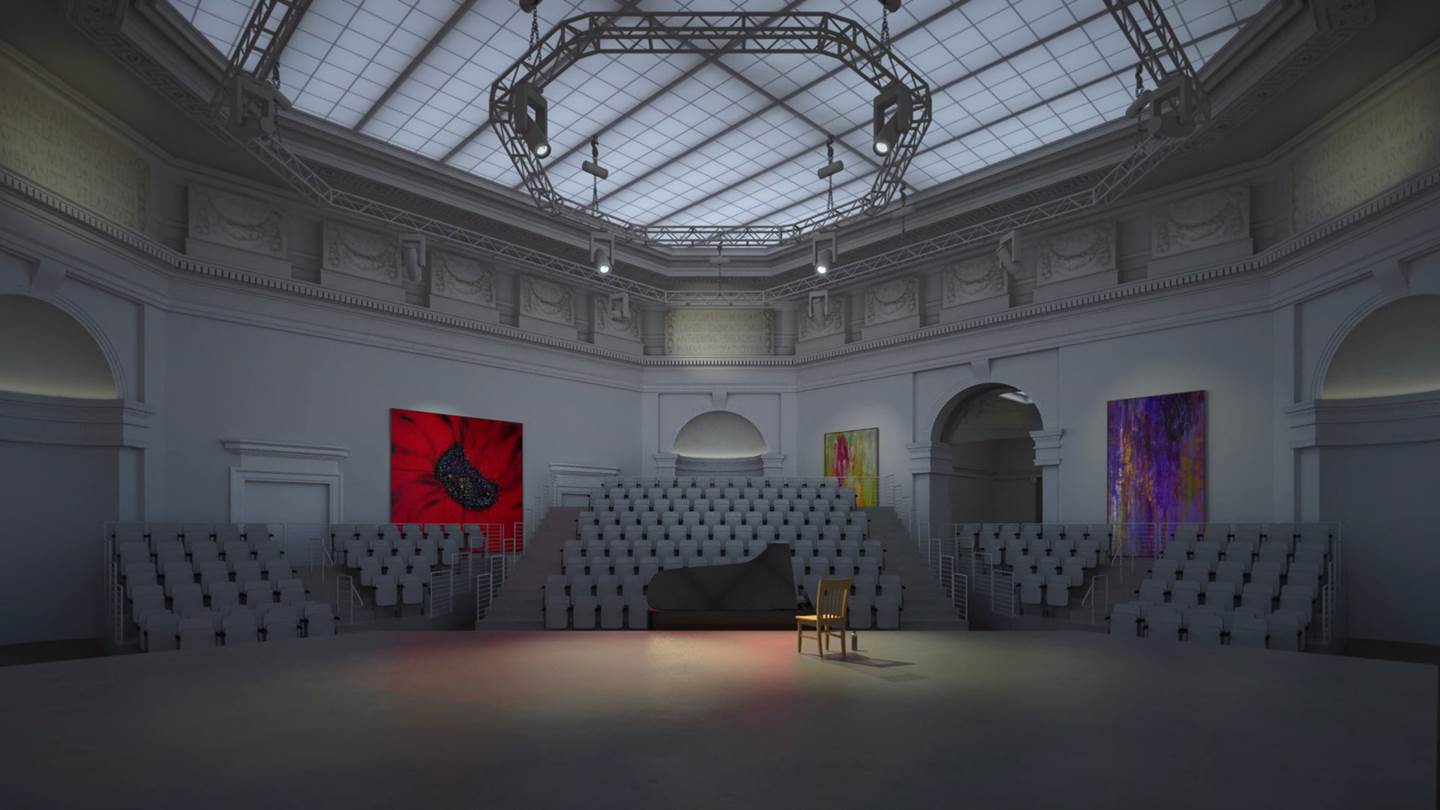 large white auditorium with a glass ceiling and an empty chair on the stage