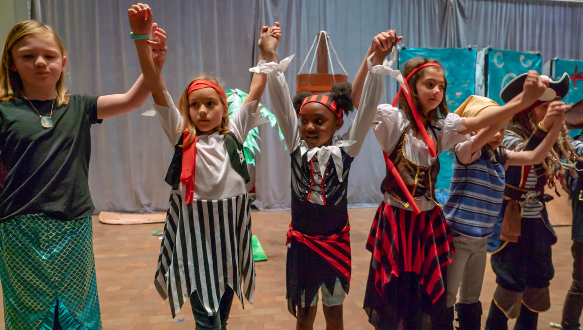 Children in costume holding hands