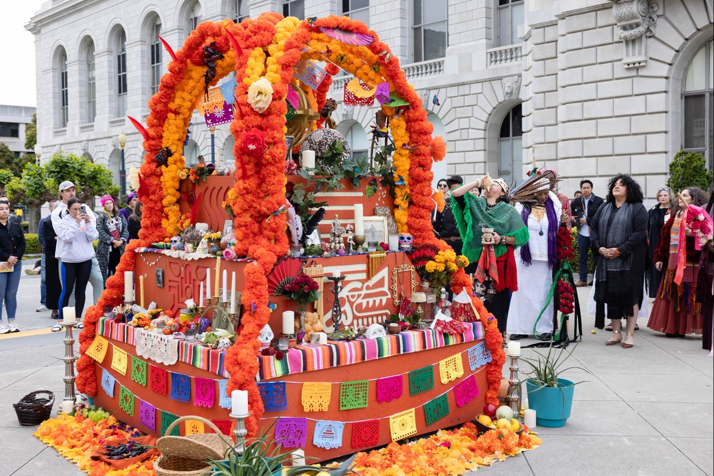 crowd looking at an altar where we will hold a unique, multicultural, ritual ceremony that dives deep into the celebrations of the stages of life and death.  