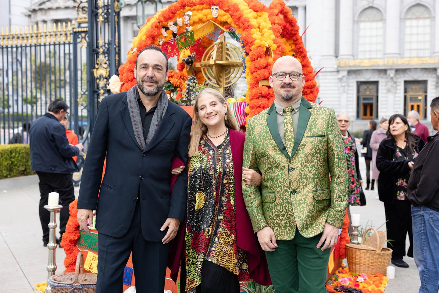 two men and a woman posing in front of the alter