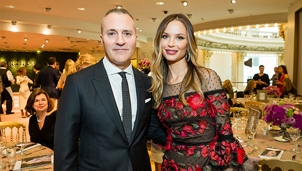 Two people dressed up at an elegant dinner party