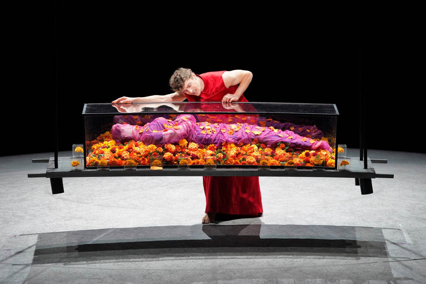 Jakub Jozef Orlinski laying over the glass casket