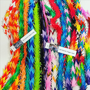 multi colored origami swan's stringed together.