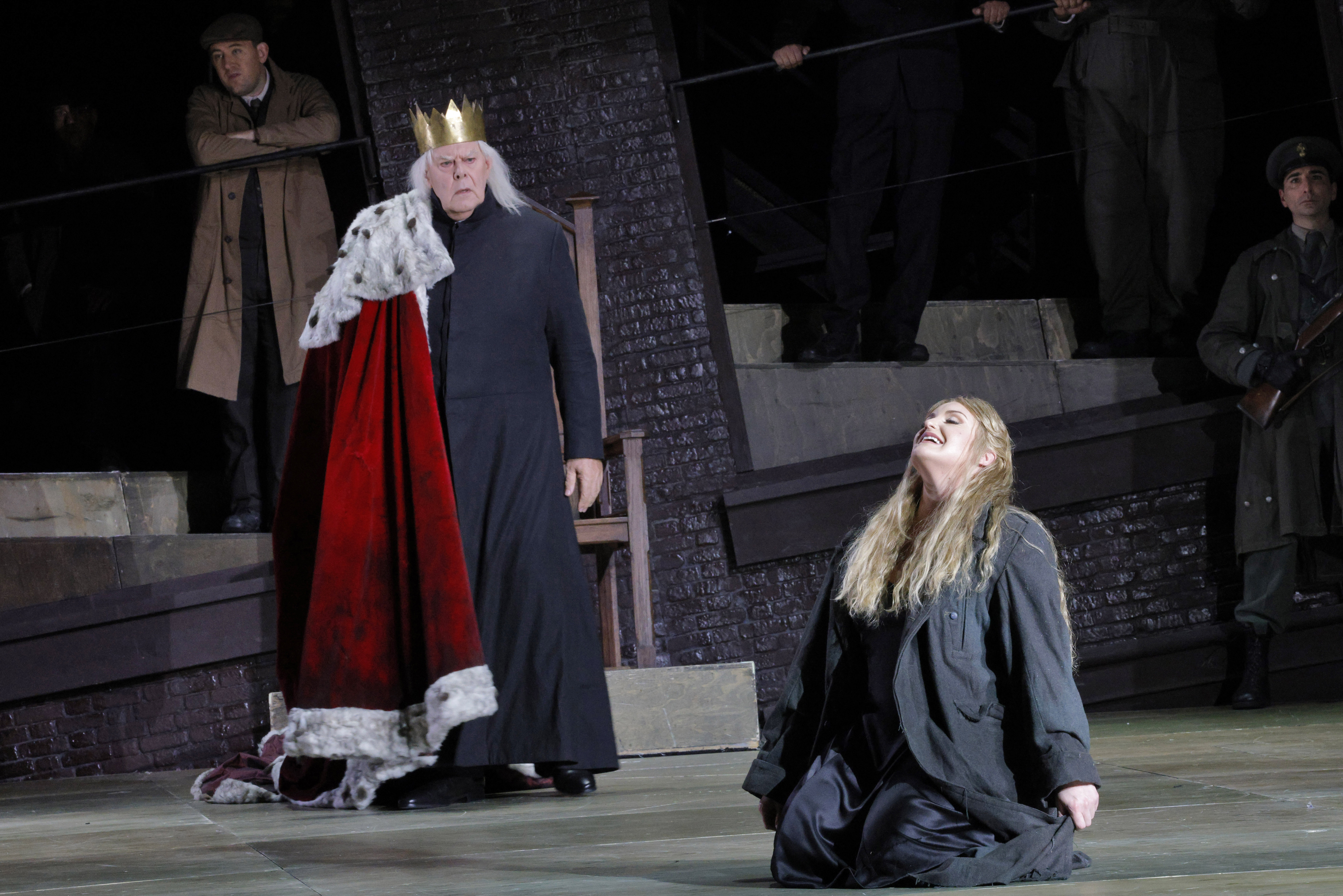 women kneeling on ground in front of king with her head heald high
